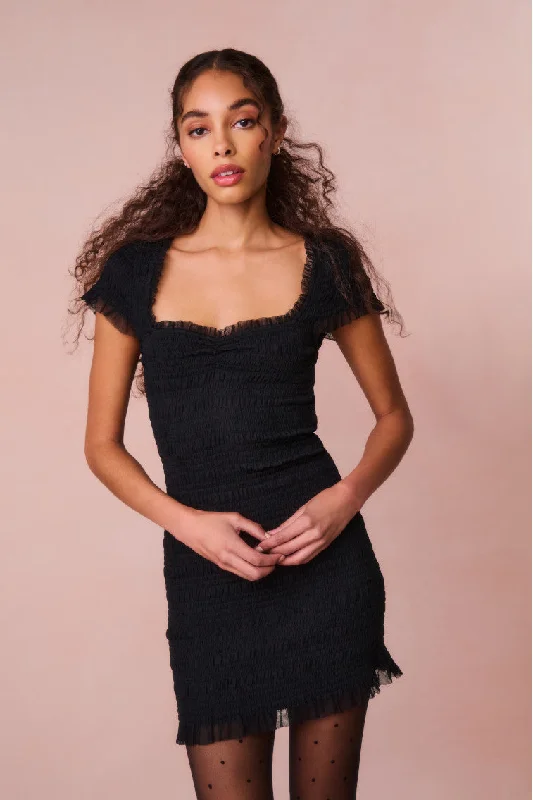 Mini dresses with asymmetric hems for a fashion - forward look Esca Smocked Mini Dress
